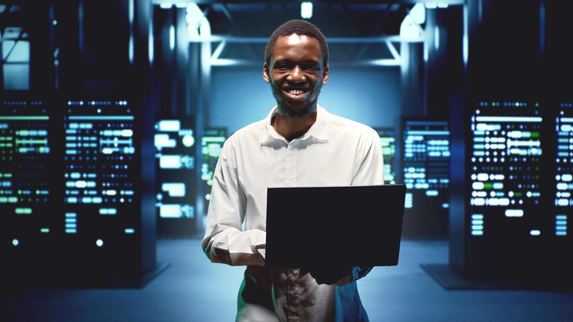 IT security professional analyzing system vulnerabilities on multiple monitors in a modern office environment